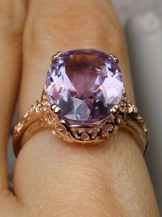 Natural Amethyst Ring Edward Design#70 In Stock Size 7 Inspired by Edwardian jewelry of the early 1900s, I now offer this lovely Antique reproduction ring in sterling silver with rose gold overlay. This gorgeous ring is set with a stunning Natural purple amethyst gemstone. This genuine amethyst has excellent color and clarity. The oval cut 3.71ct amethyst is 14mm (9/16th of an inch) Long by 10mm Wide (3/8th"). The ring sits 6mm off the finger. The inside of the band is marked 925 for sterling. N Luxury Amethyst Ring With Polished Finish, Luxury Faceted Amethyst Wedding Ring, Luxury Elegant Amethyst Ring, Luxury Oval Amethyst Ring, Art Deco Style, Luxury Oval Amethyst Ring In Art Deco Style, Rose Gold Amethyst Ring With Gemstone Accents For Anniversary, Rose Gold Amethyst Ring With Gemstone Accents For Wedding, Formal Rose Gold Amethyst Ring With Gemstone Accents, Antique Amethyst Ring