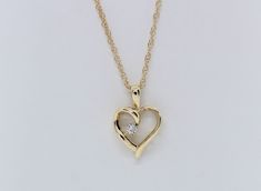 Experience the enduring charm of our 14K Yellow Gold Heart Pendant, adorned with .03 carats total weight of Lab Diamonds, and complete with an 18" Chain. This exquisite piece is skillfully handcrafted by our artisanal goldsmith at Jewelry By You. 14k Gold Heart Pendant Diamond Necklace For Anniversary, Yellow Gold Diamond Open Heart Jewelry, Yellow Gold Open Heart Diamond Jewelry, Classic Yellow Gold Heart Necklace With Diamond Accents, Fine Jewelry Yellow Gold Open Heart Diamond Necklace, Fine Jewelry Yellow Gold Diamond Necklace With Open Heart, Yellow Gold Heart Pendant With Single Diamond, Yellow Gold Heart Jewelry With Brilliant Cut, Diamond Heart Cut Birthstone Necklaces