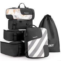 four pieces of luggage sitting next to each other in black and white stripes, with the words sky printed on them