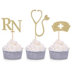 three cupcakes with white frosting in front of a stethoscope