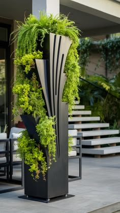 a tall planter filled with lots of green plants