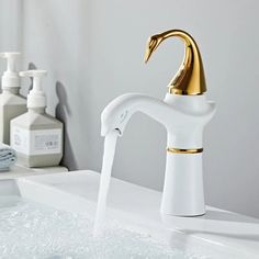 a faucet that is sitting on top of a sink with soap and lotion