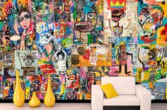 a living room filled with lots of colorful art on the wall next to a white couch