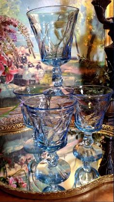 three glass goblets sitting on top of a table