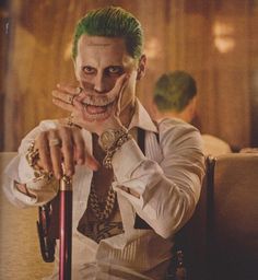 a man dressed as the joker with green hair