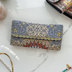 "This Boho wallet is made of Turkish carpet patterned brocade fabric and vegan leather. Its ethnicity and elegance comes from the traditional Turkish carpet motives used on the front and the back. These kilim wallets are designed and made in Cappadocia,Turkey. Cappadocia is known for its distinctive \"fairy chimneys,\" tall, cone-shaped rock formations. Besides these natural beauties, Cappodocia is famous with Its wine, horses, hot air balloons and handwoven carpets. The designs of our wallets a Beige Clutch Wallet As Gift, Beige Clutch Wallet As A Gift, Beige Clutch Wallet For Gift, Beige Clutch With Card Slots For Gift, Traditional Wallets With Card Slots, Traditional Wallets With Card Slots For Everyday Use, Beige Envelope Wallet As A Gift, Beige Envelope Wallet For Gift, Turkey Cappadocia