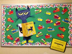 a bulletin board with a cat reading a book