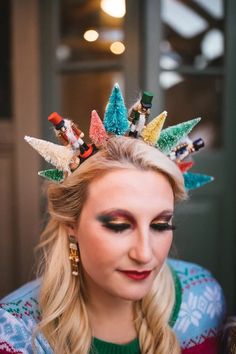 a woman with long blonde hair wearing a colorful crown