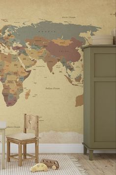 a room with a map on the wall next to a chair and table in front of it