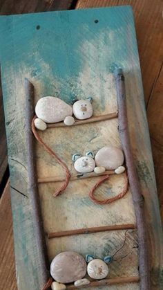 there is a small boat made out of rocks and driftwood on the beach with rope