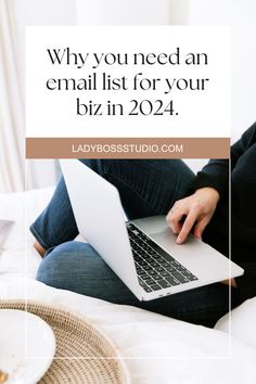 a woman sitting on her bed using a laptop with the words why you need an email list for your biz in 2021