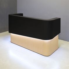 a black and white reception table with lights on it's sides in an empty room