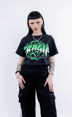 Show your allegiance in this rad green crop designed exclusively for Tragic Beautiful by @brydiebrutal. Bringing us back to our emo roots with a hint of sk8ter boi vibe thrown in too. Available in sizes XS-5XL. We have plus sizes available here. Check the sizing chart for measurements or feel free to contact us for more assistance. Model 1 is wearing a size M Model 2 is wearing a size XS Made from high-quality fabric and screen printed with care. We produce ethically through building relationships with small businesses here and overseas that fit within our ethical framework. Fabric: 50% cotton and 50% polyester which has a slight stretch for a flattering and comfortable fit. Care Instructions: Hand wash. Do not bleach. Do not tumble dry. Iron at low temperature inside out and avoid the pri Occult Fashion, Building Relationships, Animal Fur, Crop Tee, Sizing Chart, Alternative Fashion, Shades Of Green, Dyed Hair, Small Businesses