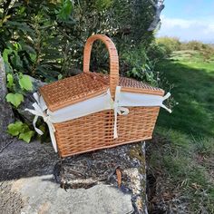 a wicker basket sitting on top of a rock