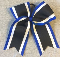 "Gorgeous 3 layer bow with Royal Blue, White, and Black ribbon.   Bow is approx. 7\" tall and 6\" wide at ears. Ponytail attach. Team discounts available. Just message us." Adjustable Blue Bow For Formal Occasions, Royal Blue Bow Tie, Red White And Blue Cheer Bows, Adjustable Blue Ribbon Bow, Blue And White Cheer Bows, Blue White And Black, Black Ribbon, Ribbon Bow, Hair Ties