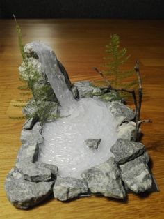 a small fountain made out of rocks and water