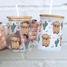 two people holding cups with animals on them