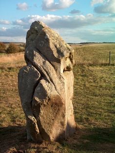 a large rock sitting in the middle of a field