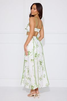 Length from bust to hem of size S: 107cm. Chest: 38cm, Waist: 34cm, across front only of size S. Maxi dress. White dress, green print. Semi-lined. Model is a standard XS and is wearing size XS. True to size. Non-stretch. Green trim and pattern. Pleated detail to top. Cutout to waist. Elastic back. Flowy skirt. Zipper. Print placement may vary. Cold hand wash only. Polyester. Soak up the sunshine in the Summer Garden Maxi Dress. Featuring a dreamy pattern, a pleated top and a cutout to the waist. Style with sandals and curls for a 'fit we are in love with. Maxi Dress White, Brunch Dress, Prom Shopping, Skirt Zipper, Printed Summer Dresses, Pleated Top, Maxi Robes, Print Placement, Maxi Dress Green