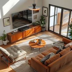 an overhead view of a living room with couches, coffee table and television set