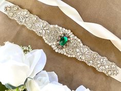 "-This listing is for the gorgeous emerald rhinestone bridal sash shown above. It features rhinestone and pearl beading on a sash width of your choice. Shown in 1\" bridal white satin.- -Beading available in longer and shorter lengths, please browse my listings or contact me for other sizes.- ---------IMPORTANT INFORMATION------ PLEASE READ MY MAIN PAGE BANNER AS WELL AS MY SHOP POLICIES BEFORE PURCHASE. Policies- https://www.etsy.com/shop/TheRaggedDiamond/policy?ref=shopinfo_policies_leftnav Ho Wedding Renewal Ideas 10 Year, Belt Wedding Dress, Emerald Green Wedding, Bridesmaid Sash, Bridal Sash Belt, Emerald Green Weddings, Pearl Beading, Wedding Dress Sash, Wedding Belt