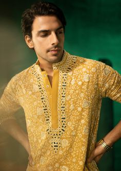 The garment is made in georgette, with chikankari embroidery patterns designed, embroidered and embellished with mirrorwork in house, and styled by the designers at our studio with the finest details. Chikankari Shirts For Men, Diwali Kurta For Men Indian, Mirror Work Kurta Design For Men, Kurtas For Haldi For Men, Haldi Kurta For Men Yellow, Haldi Outfit For Men Indian, Indian Mens Wedding Outfit, Yellow Kurta Pajama Men, Designer Yellow Kurta With Chikankari Embroidery