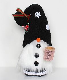 a white and black snowman with a cup in his hand