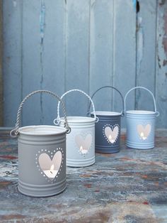 three buckets with hearts and the words in loving memory