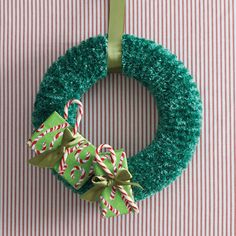 a green christmas wreath with candy canes on it