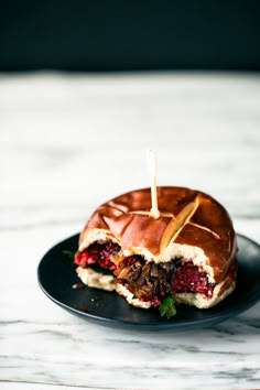 a sandwich on a plate with toothpicks sticking out of it's middle