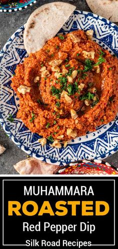 a plate filled with red pepper dip next to pita bread