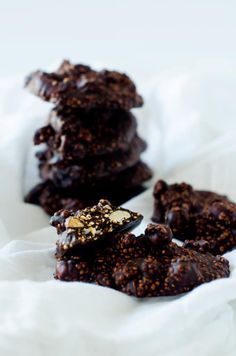 chocolate cookies stacked on top of each other with nuts in the middle and one broken