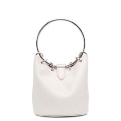 White leather bucket bag from Alaïa. The Ring medium bag is made of white leather with a silver-finish top-handle, magnetic fastening and internal leather pouch to fit all your belongings.Measurements: L19 x H19 x W19 cmMade in Italy Chic Bucket Bag With Silver-tone Hardware For Shopping, Chic Shopping Bucket Bag With Silver-tone Hardware, White Top Handle Shoulder Bag With Metal Hardware, Modern White Bag With Round Handle, White Top Handle Bag With Palladium Hardware, White Tote Shoulder Bag With Metal Hardware, Evening Bucket Bag With Silver-tone Hardware, Chic Silver Leather Bucket Bag, Modern White Shoulder Bag With Metal Hardware