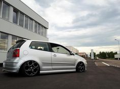 a white car parked in front of a building