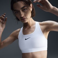 You're on the move. Your padding shouldn't be. This Swoosh bra's sewn-in pads stay in place so you can work hard without worrying about them shifting or folding. Great for training workouts and dance classes, medium support gives you a snug hold that helps keep everything in place. Plus, sweat-wicking, adaptive material quickly recovers its shape so you can stay comfortable throughout your workout. Bra Sewing, Training Workouts, Dance Classes, White Sports Bra, Padded Sports Bra, Nike Sports Bra, Women Lifestyle, Nike Sports, Nike Swoosh