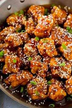 sesame chicken in a bowl with sesame seeds on top