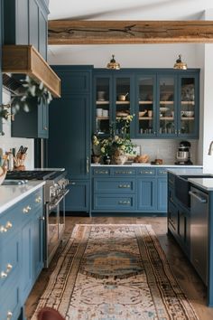 a kitchen with blue cabinets and an area rug