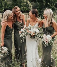 bridesmaids laughing together in the field with their bouquets