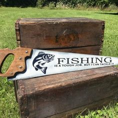 a fishing sign sitting on top of a wooden box