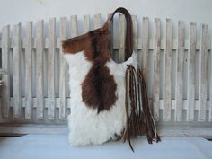 BROWN WHITE TOTE with Woven Leather Tassels Calf Hair Bag with Hand Leather Cross Weave Country South Western Cowgirl Fur Bag Shoulder bag. Introducing our Brown White Tote, a must-have accessory that seamlessly blends style and practicality. Crafted with meticulous attention to detail, this shoulder bag features woven leather tassels and calf hair, embodying the essence of South Western Cowgirl chic. Indulge in luxury with our handpicked cow hides, ensuring each piece boasts unique markings for Brown Tasseled Bags For Shopping, Brown Tassel Bags For Shopping, Brown Shopping Bags With Tassels, White Double Handle Hobo Bag With Leather Handles, White Rectangular Hobo Bag With Leather Handles, White Tassel Shoulder Bag For Travel, White Travel Bags With Tassels, White Fringe Travel Bag, White Tassel Travel Bags