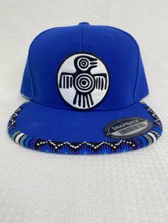 You are viewing a hand-beaded baseball hat with thunderbird patch. The hat is ADULT size. All beads are sewn by hand.  All patches are applied by hand. No two hats are exactly alike and will never be replicated exactly. Made by an indigenous artist, I am an enrolled member of the Jumano Nation of West Texas. Free shipping to US locations only Traditional Adjustable Snapback Baseball Cap, Traditional Adjustable Snapback Hat, Metis Beadwork Patterns, Metis Beadwork, Bead Hat, Beaded Hats, Hat Burning, Beaded Ideas, Beaded Hat