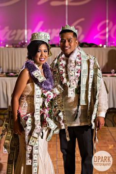 a man and woman standing next to each other in front of a table with money on it