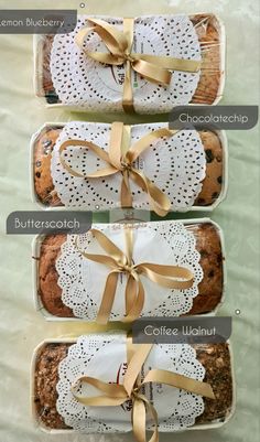 four different types of bread wrapped in paper and tied with gold ribbon on top of each other