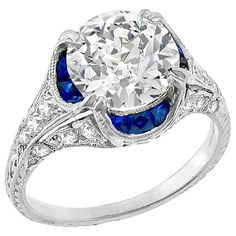 a diamond and blue sapphire ring with an old - fashioned style setting on the side