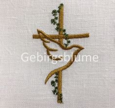 the cross is made up of gold thread and green leaves on white linen with an embroidered design