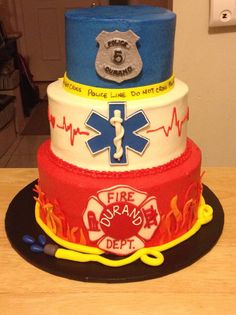 three tiered cake decorated with fire and rescue symbols