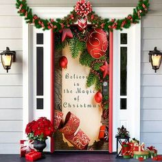 a decorated front door with christmas decorations and presents