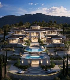 an aerial view of a large mansion with pool and landscaping at dusk, surrounded by mountains