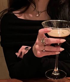 a woman holding a martini glass in her hand