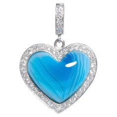 The heart shape pendant features at the center hand cut banded blue agate. It is surrounded by a crown of round diamonds set en pavé and attached to a hook set with diamonds. The total weight of diamonds of top quality is 0.40 carats (F/G-VVS). The pendant is one-of-a-kind. It was handmade in 18 carat white gold with exquisite workmanship and knowhow in our own workshop in Italy by maestro Pierpaolo according to an original design by Ella Gafter. The item is signed EG. The pendant is shown on a simple chain in the picture carousel, to give an idea of its size when worn. It measures 0.75 x 0.75 inches. Simple Chain, Round Diamond Setting, Heart Shaped Diamond, Heart Shape Pendant, Blue Agate, Diamond Design, Diamond Heart, Heart Shape, Original Design